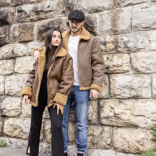 couple presenting brown leather jacket